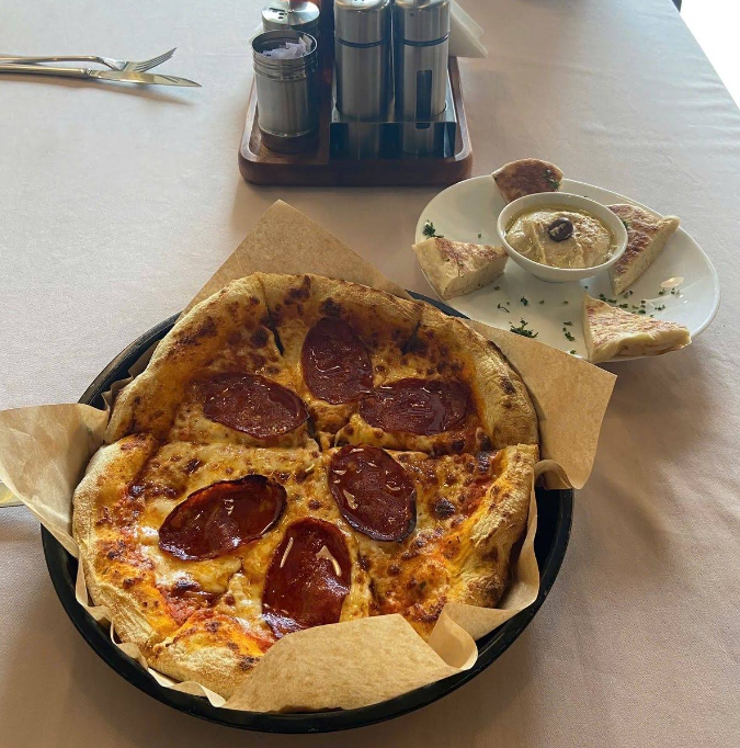 Pepperoni pizza and dip photo from Camelia's Google review